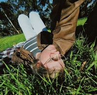 a woman laying in the grass